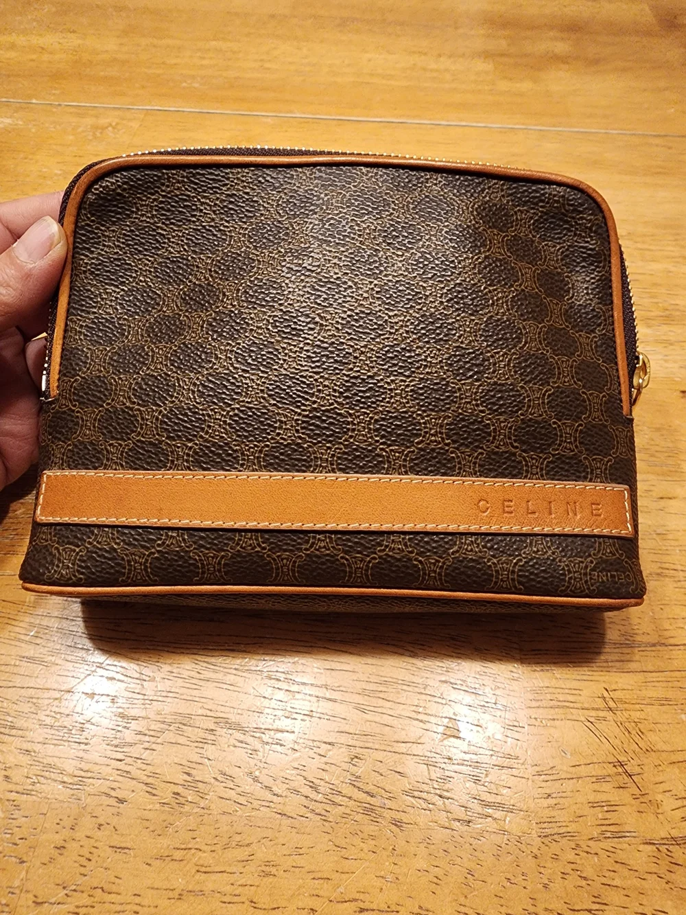 CELINE pouch is crafted from brown Triomphe canvas and features tan leather trim